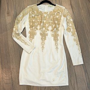 White and gold lace dress with small stains at the bottom of the dress.